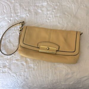 Coach small leather wristlet in soft buttery yellow with gold hardware.